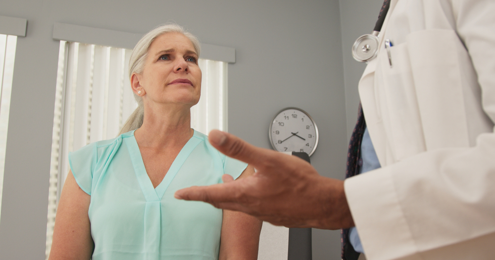 physician discussing treatment plan with patient in medical office